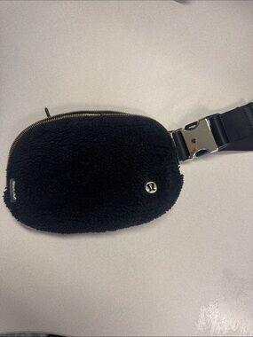 lululemon black sherpa pouch with gold zipper